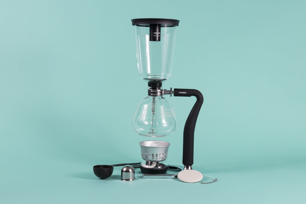 Hario Next Coffee Syphon on its metal stand with burner and accessories